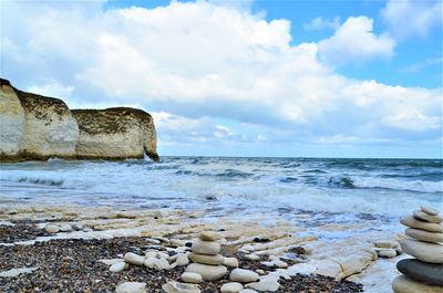 Rocks on beach against sky