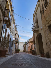 Narrow alley amidst buildings against sky