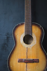Close-up of guitar against black background