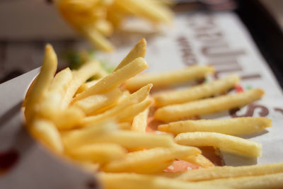 Close-up of french fries in containers on table