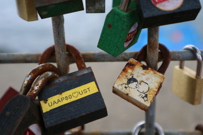 Close-up of padlocks hanging on railing