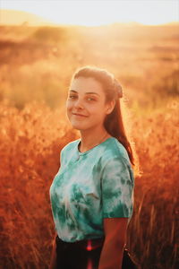 Portrait of a smiling girl standing on field