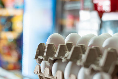 Detail view of white chicken eggs placed in a carton. sale of eggs in a grocery store. eggs rich