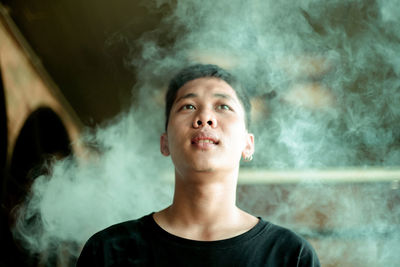 Portrait of young man smoking