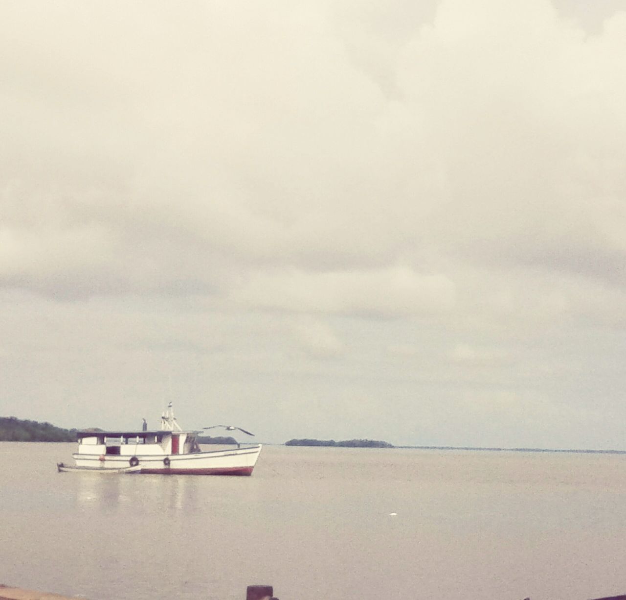 nautical vessel, water, transportation, boat, sky, mode of transport, sea, tranquility, tranquil scene, moored, cloud - sky, scenics, nature, beauty in nature, cloudy, waterfront, overcast, weather, cloud, outdoors