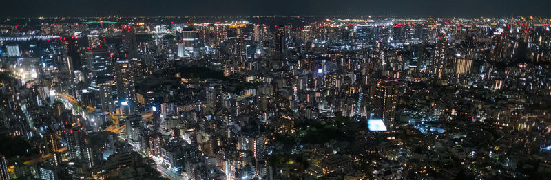 High angle view of illuminated city buildings at night