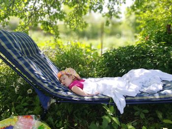 Side view of boy sleeping on grass