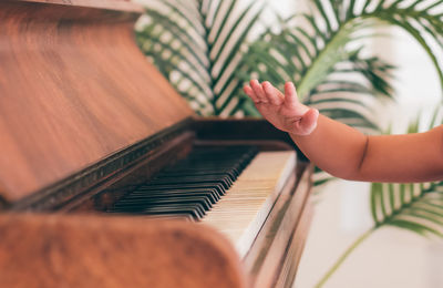 Midsection of woman playing piano