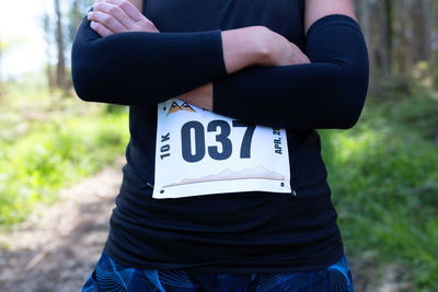 Midsection of woman with text
