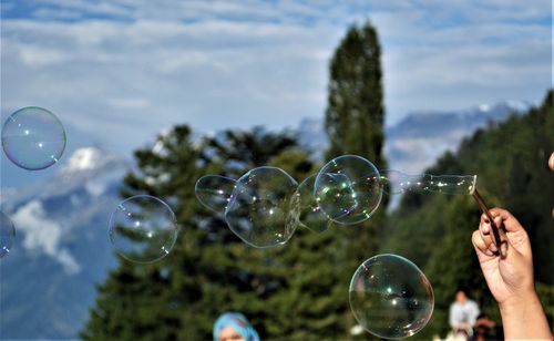 View of bubbles in mid-air against sky