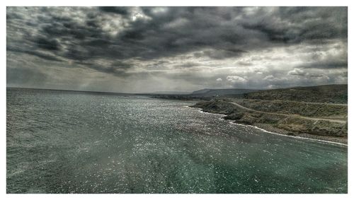 Scenic view of sea against cloudy sky