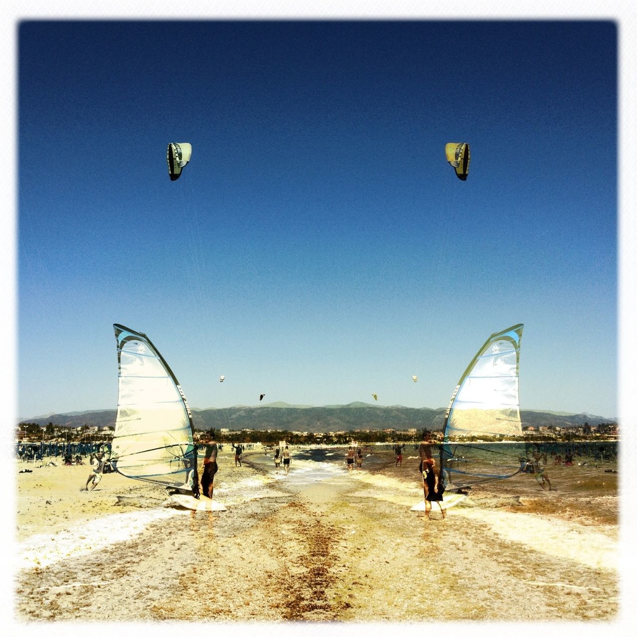 beach, clear sky, sand, flying, leisure activity, transportation, blue, parachute, transfer print, lifestyles, copy space, sky, mid-air, sea, sport, vacations, incidental people, men, auto post production filter