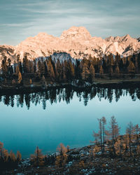 Scenic view of lake by rock formation against sky