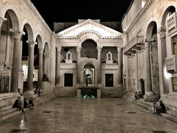 Group of people in front of historic building