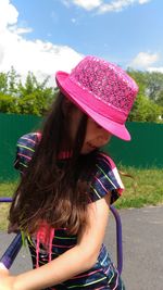 Girl wearing pink hat while playing at playground