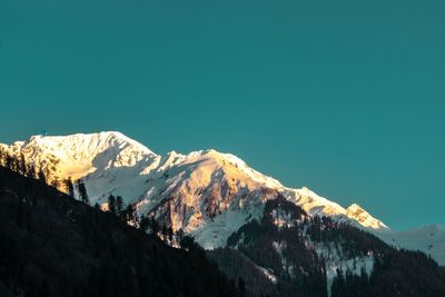 Scenic view of snowcapped mountains against clear sky