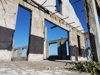 Low angle view of old ruin against sky