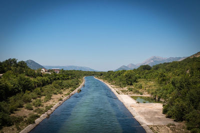 Scenic view of mountains against clear blue sky