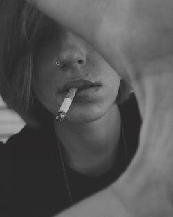 Close-up of young woman smoking cigarette