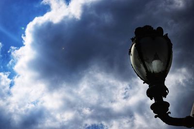 Low angle view of silhouette statue against sky