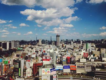 Buildings against cloudy sky