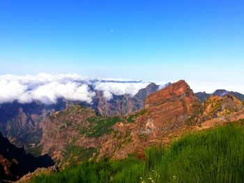 Scenic view of mountains against clear blue sky