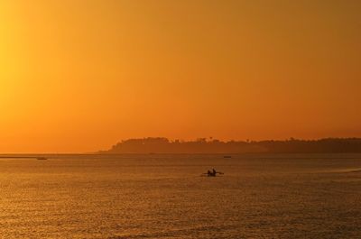 Scenic view of sea against orange sky