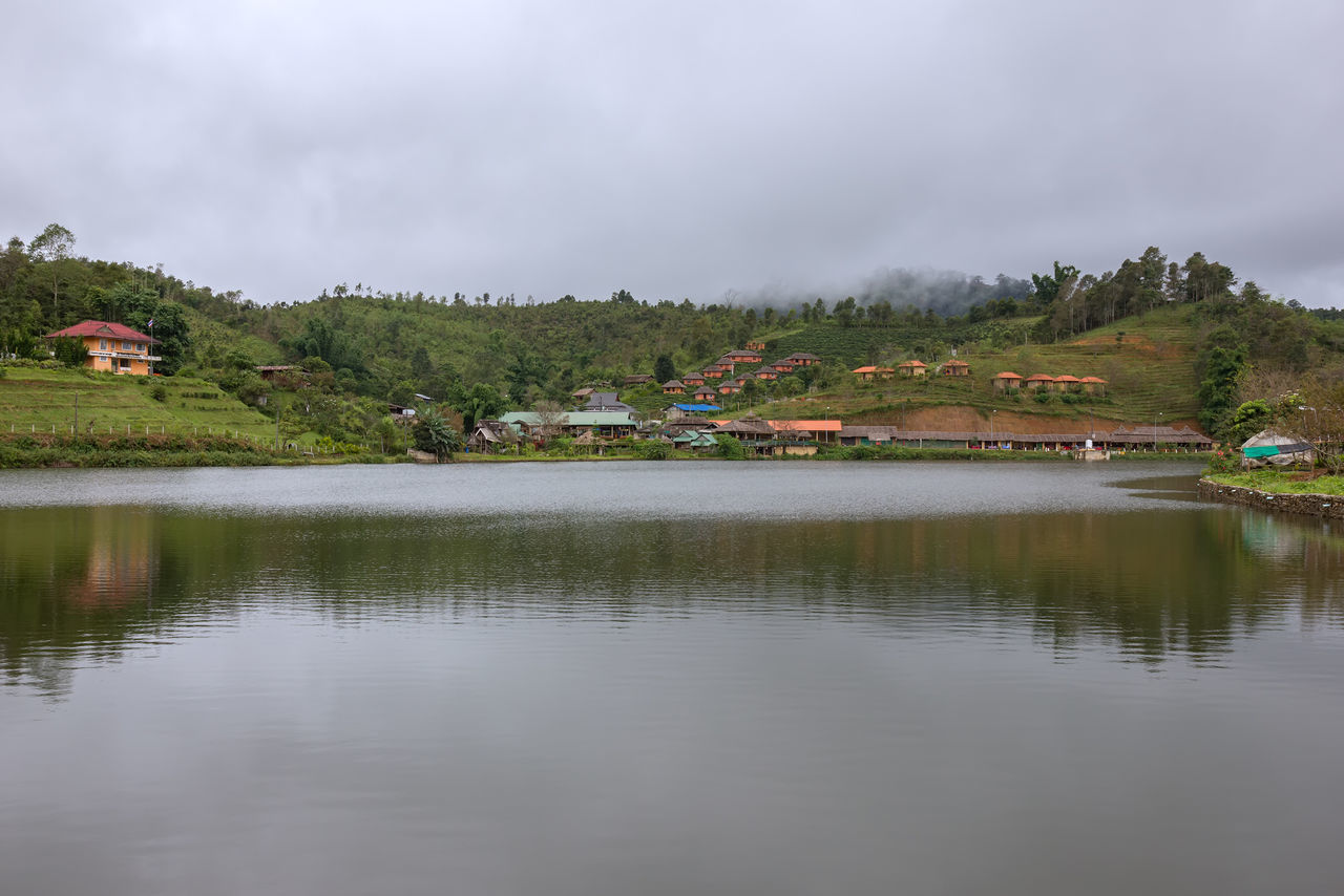 SCENIC VIEW OF LAKE AGAINST BUILDINGS AND SKY