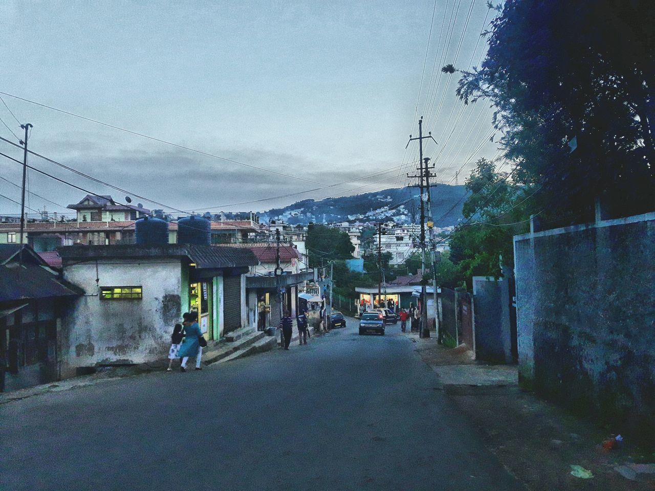 PEOPLE WALKING ON ROAD AGAINST SKY