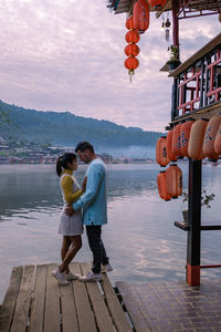 Rear view of woman standing on pier