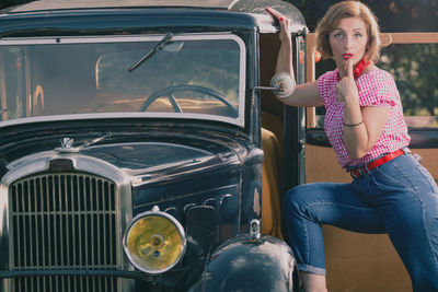 Portrait of young woman sitting in car