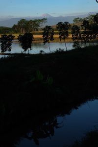 Scenic view of lake against sky at sunset