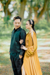 Portrait of smiling couple standing outdoors