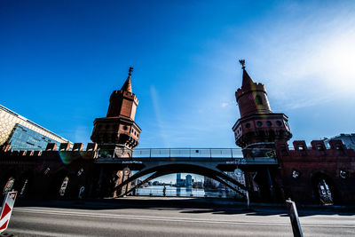 Arch bridge in city against sky