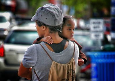 High angle view of mother and daughter looking away