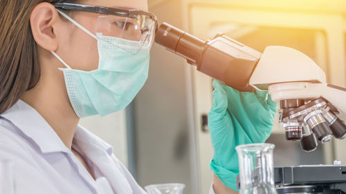 Close-up of scientist examining in laboratory