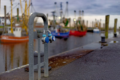 Metal construction in front of fish trawlers in a port