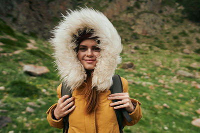 Portrait of smiling young woman wearing hat