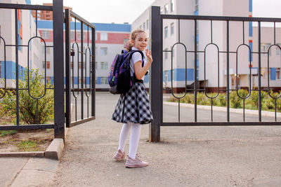 Back to school. girl in school uniform go to school with backpack behind their backs. beginning 