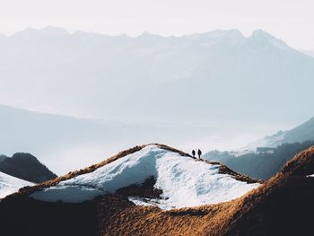 Scenic view of snow covered mountains against sky