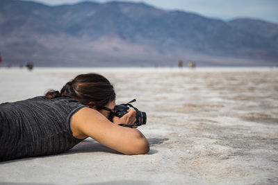 Woman with camera on beach