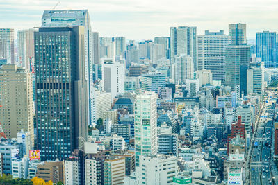 Aerial view of modern buildings in city against sky