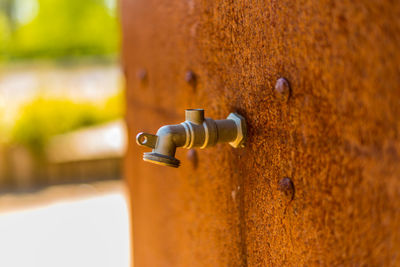 Close-up of rusty handle on wall