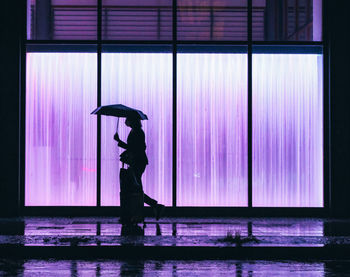 Silhouette man on glass window