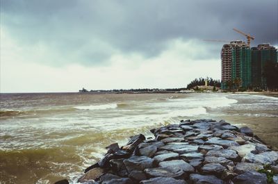 Scenic view of sea against cloudy sky