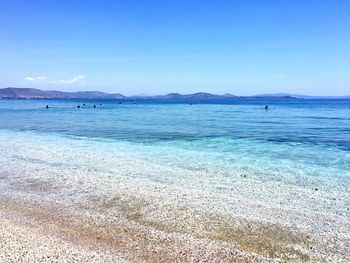 Scenic view of beach against blue sky