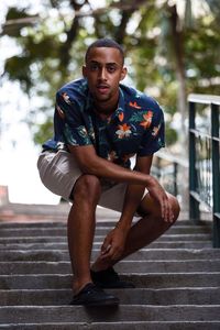 Portrait of young man sitting outdoors