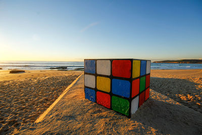 Scenic view of beach against sky during sunset