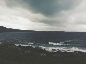 Scenic view of sea against cloudy sky