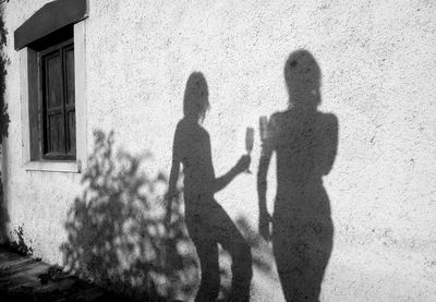 Shadow of man walking on footpath